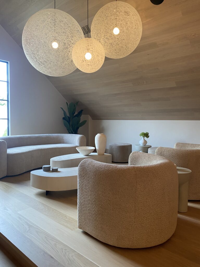 Curved sofa and chairs in attic lounge